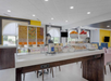 Breakfast area with a variety of breakfast items, assorted fruits and cereals.