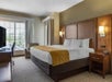 One Queen bed inside a guest room.
