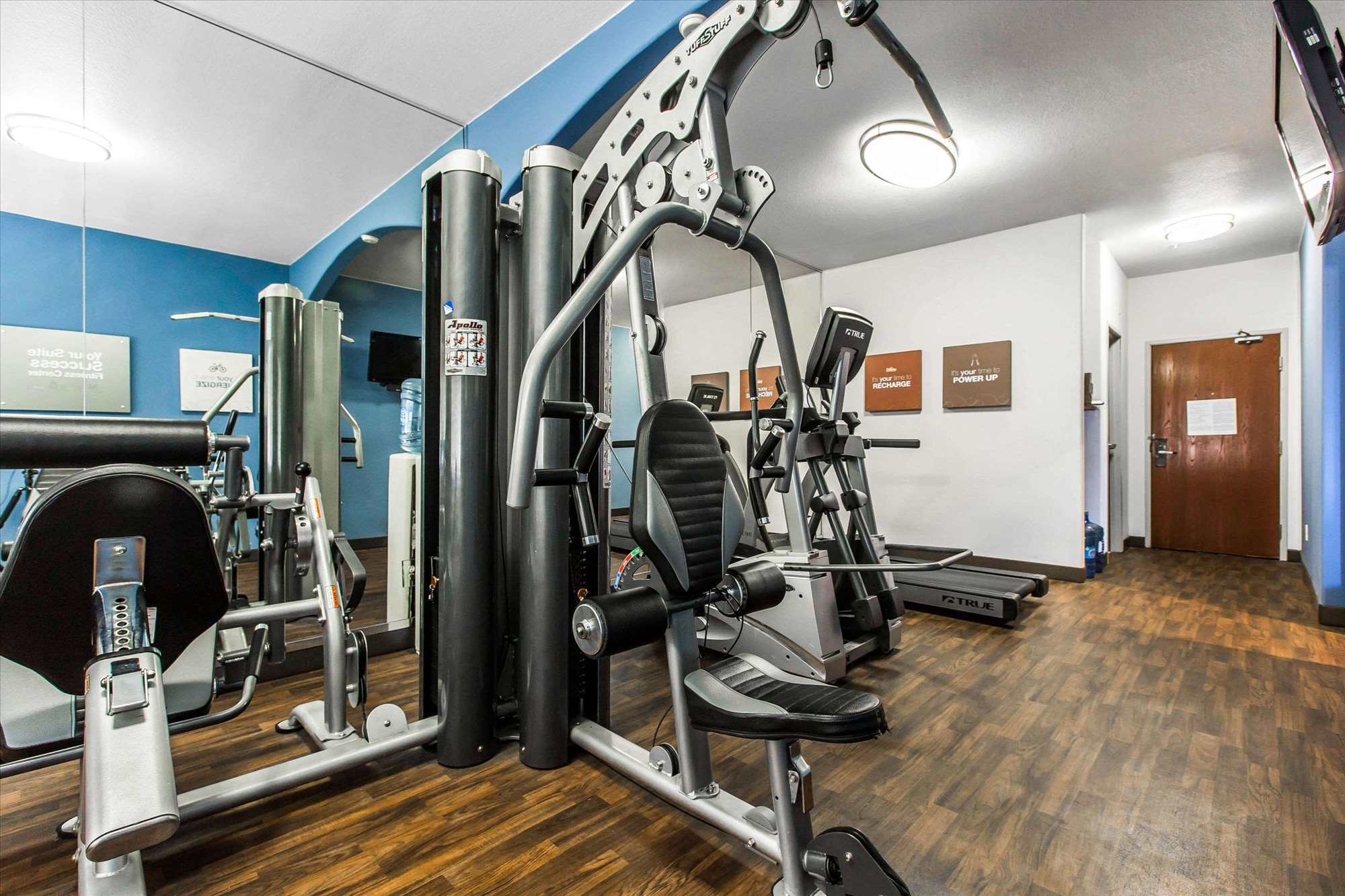 Fitness center with treadmill and other gym equipment.