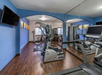 Fitness center with treadmill and other gym equipment.