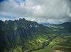 A helicopter flying along the mountains in Oahu on the Complete Island Oahu Helicopter Tour in Hawaii USA.