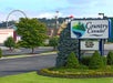 Hotel parking lot with a "Country Cascades" sign in the foreground and a Ferris wheel visible in the background.