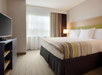 Guest room with one king bed and a work desk