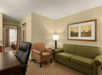 Living area inside a guest room at Country Inn & Suites by Radisson, Doswell (Kings Dominion), VA.
