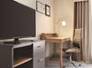 Guest room amenities include TV, and a work desk and chair