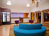 Lobby with seating area, front desk, and corner market.
