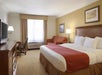 One king bed, sofa bed, desk, chair and a flat-screen TV inside a non-smoking room.