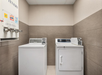 Guest laundry with coin-operated washing machine and dryer.
