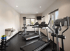 Fitness facility with treadmill and stationary bike.