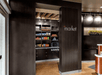 A small market area with dark wooden shelving and a plethora of snacks at the Courtyard Columbus Easton.