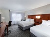 Two queen beds, work desk and chair and a flat-screen TV.