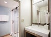 Guest bathroom with a walk-in glass-enclosed shower.