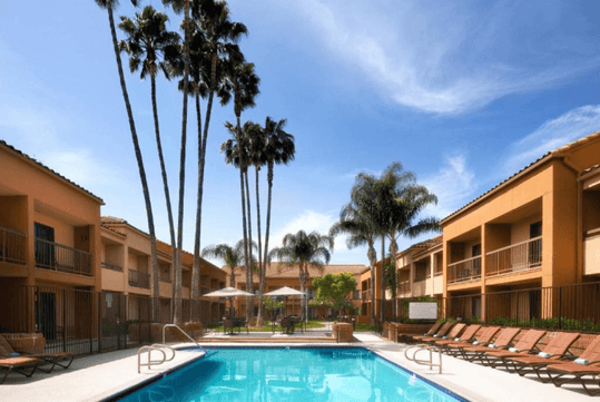 Outdoor pool with sun loungers.