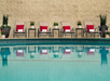 Outdoor pool with sun loungers.