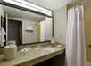 Private bathroom with vanity area and toiletries.