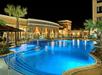 Outdoor pool with sun loungers.