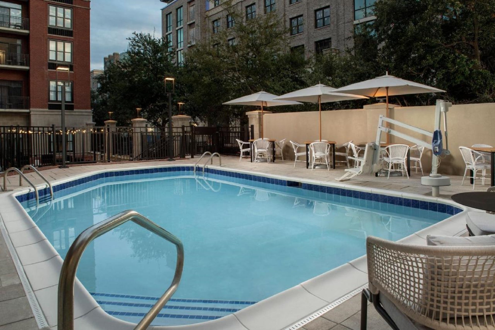 Outdoor pool with sun loungers.