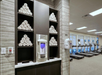A gym with rolled towels on shelves, a water dispenser, and several treadmills.