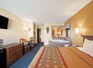 A King bed and a hot tub inside a guest room at Days Inn Charlotte/Woodlawn Near Carowinds.