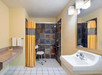 Fresh towels and an accessible shower inside a private bathroom.