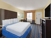 One king bed, microwave, mini-fridge, flat-screen TV and a flat-screen TV inside a non-smoking room.