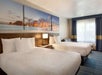 Guest room with two queen beds and a seating area.