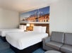 Guest room with two queen beds and a sofa bed.