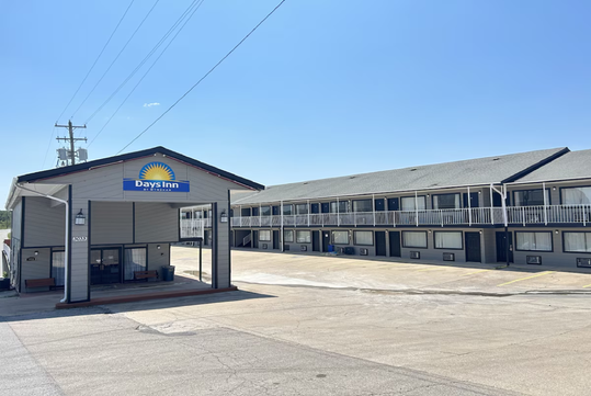 Hotel exterior under a clear blue sky.