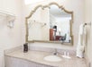 Vanity mirror with toiletries and towels at Days Inn by Wyndham Destin.