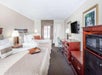 2 Queen beds, a mini refrigerator, microwave and seating area at Days Inn by Wyndham Destin.