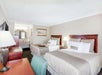 2 Queen beds, a desk and chair at Days Inn by Wyndham Destin.