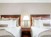 2 Neatly arranged Queen beds at Days Inn by Wyndham Destin.