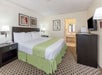 One king bed, flat-screen TV and a work desk inside a private suite.