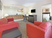 A spacious seating area inside a private suite.