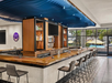 Indoor bar with view of the pool area.
