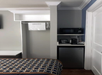 Microwave and a mini-refrigerator inside a guest room.