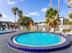Children's pool, playground, and outdoor pool with lounge chairs.