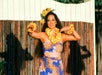 The sunlight reflects to the wonderful hula show dancer while performing in front of the guests.