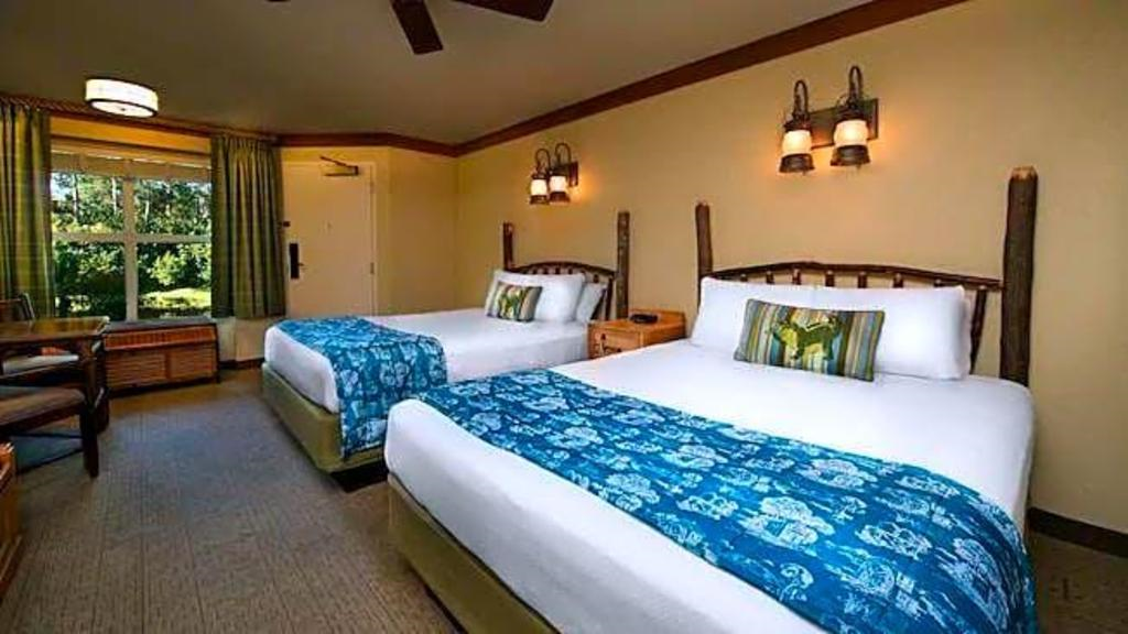Two queen beds inside a guest room.