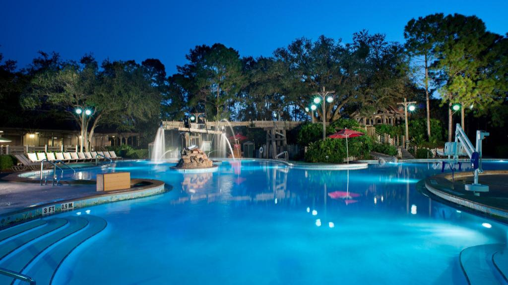 Outdoor swimming pool with water fountains.