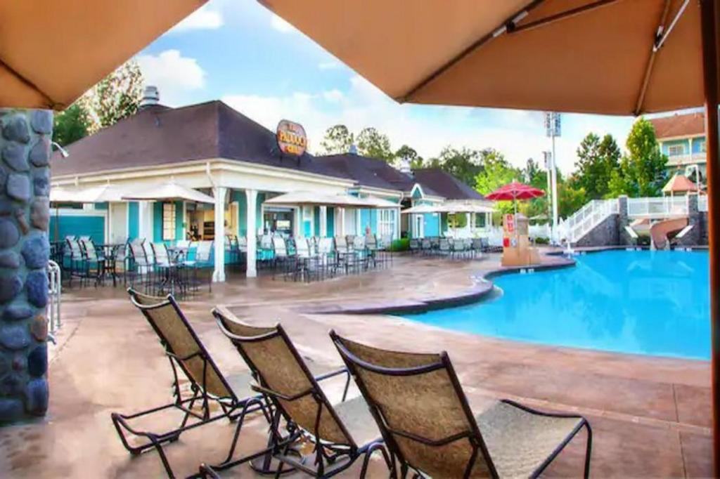 Outdoor pool area with sun loungers.