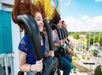Young adults riding the Dominator and laughing on a sunny day at Dorney Park in Allentown, Pennsylvania.