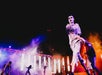 Performers in zombie costumes dance on a stage with dramatic lighting and smoke effects during a night show.