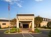 Entrance of DoubleTree Resort with a well-maintained garden, flags, and clear blue sky.