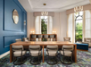 Modern meeting room with long wooden table, eight chairs, blue accent wall, large windows, and contemporary lighting fixtures.
