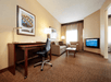Living area with soft seating, flat-screen TV and a spacious work desk at DoubleTree Suites by Hilton Hotel Cincinnati - Blue Ash, OH.