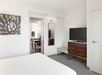 One king bed and a flat-screen TV inside a guest room.