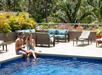 Outdoor pool with sun loungers.
