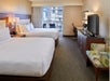 Two queen beds inside a guest room.