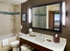 Private bathroom with vanity area and toiletries.